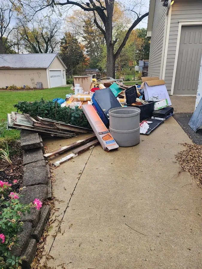 Dumpster being loaded with debris for Estate Cleanout Dumpster Rental in Englewood
